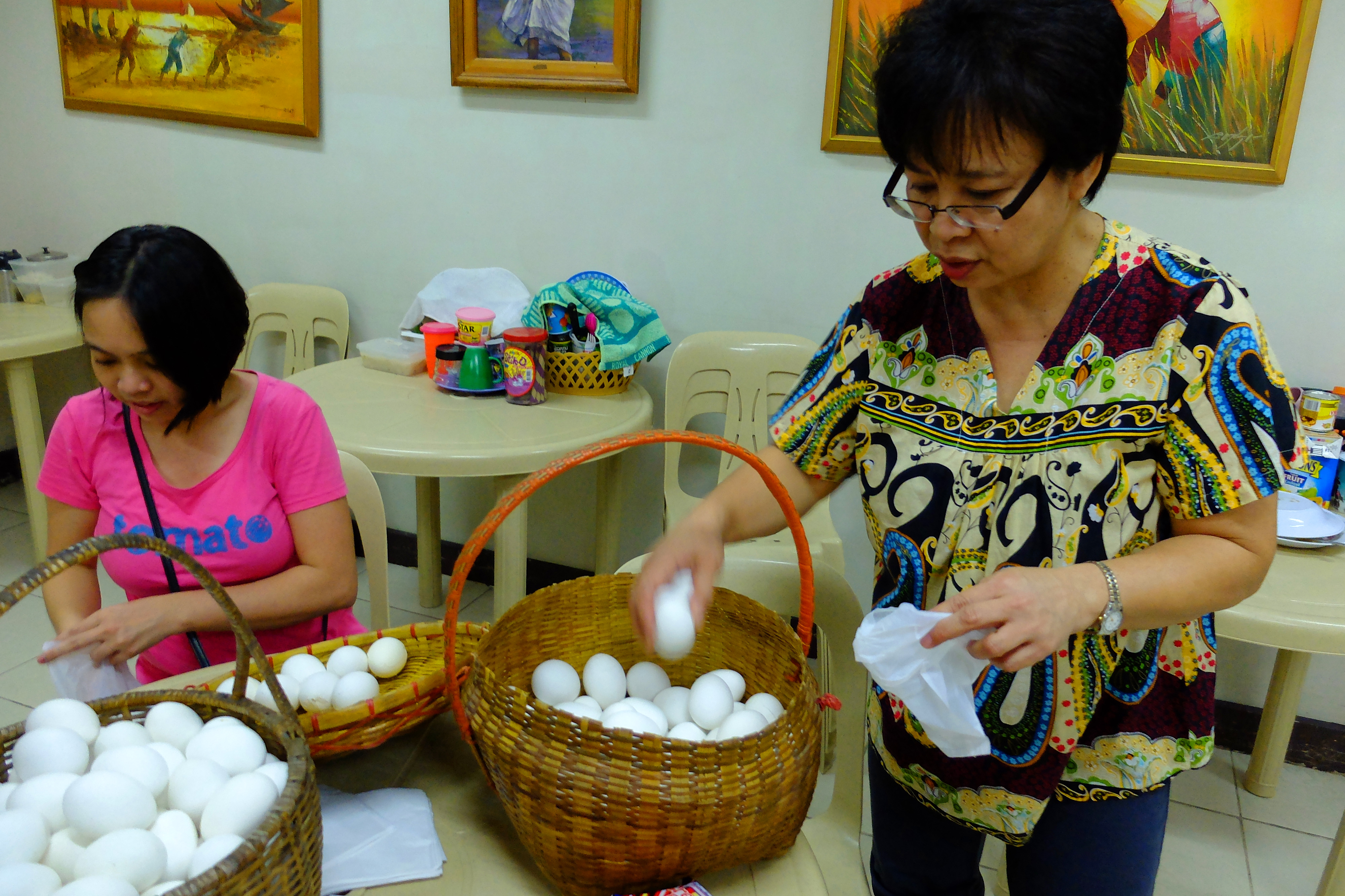 Becky and NCPAG Library staff Mayzel Marifosque sorting and packing eggs.